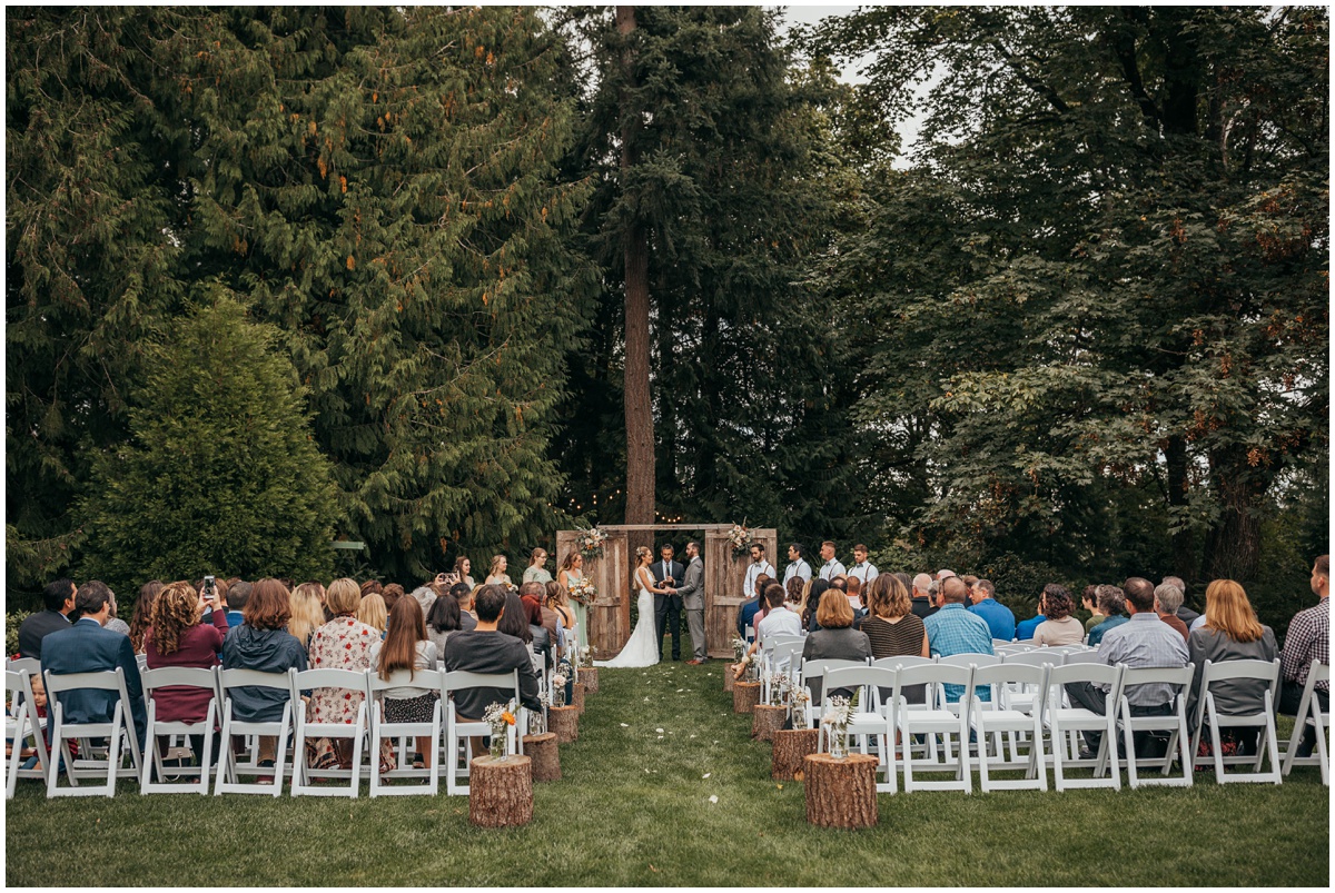 bride and groom getting married in front of guests | glenwood treefarm tacoma washington photographer