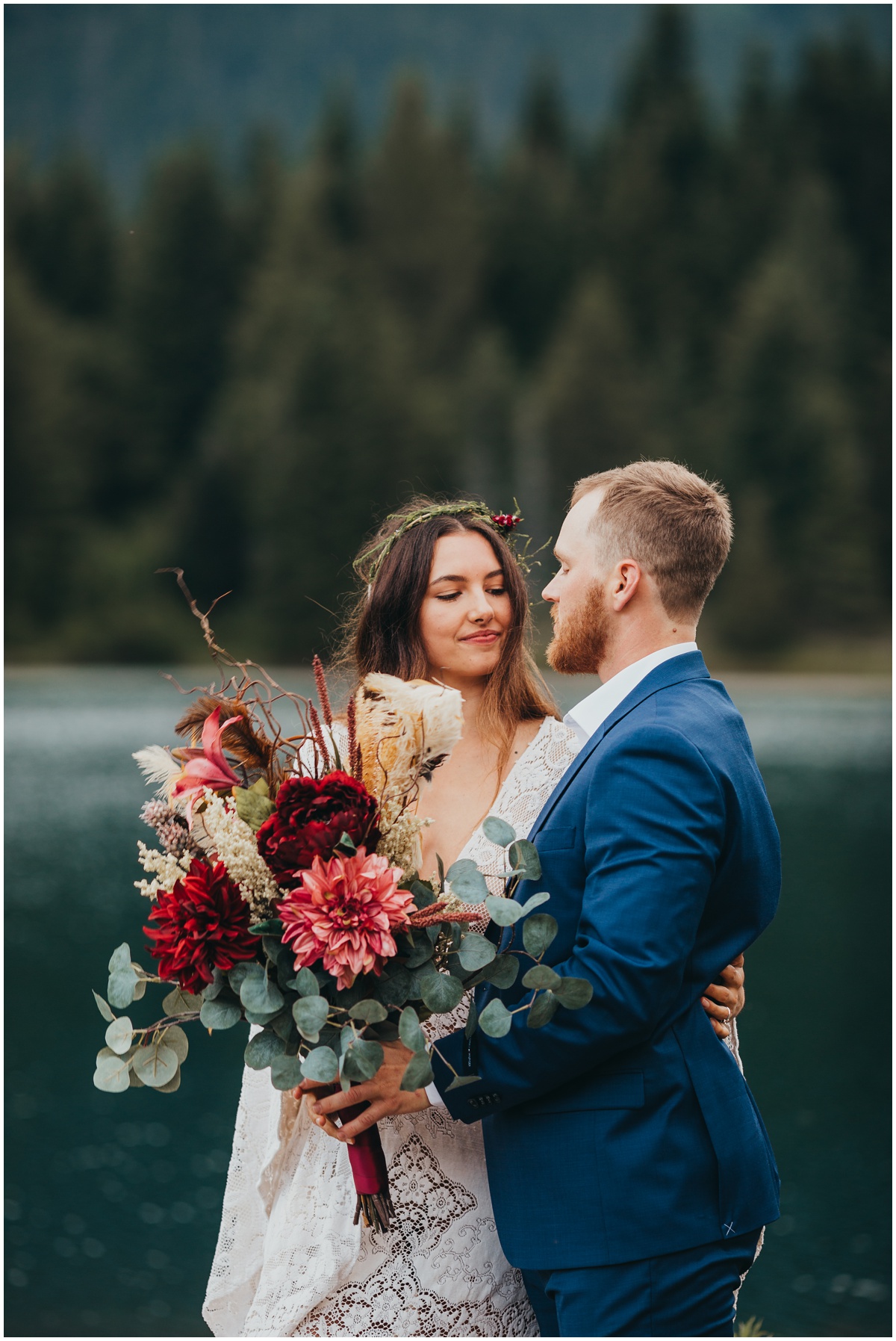 bride and groom pose with boho flowers | Gold Creek Pond Washington Elopement Photographer