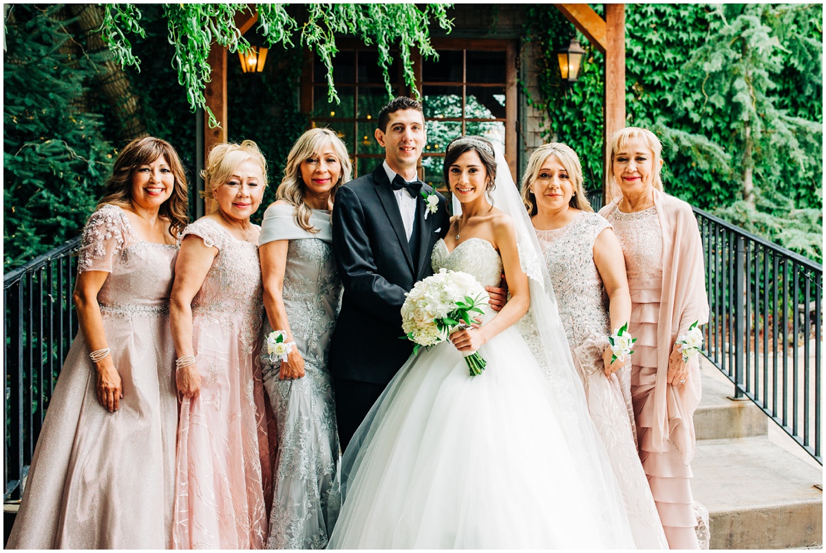 bride and groom pose with brides mother and aunts | Hidden Meadows Wedding Snohomish Washington
