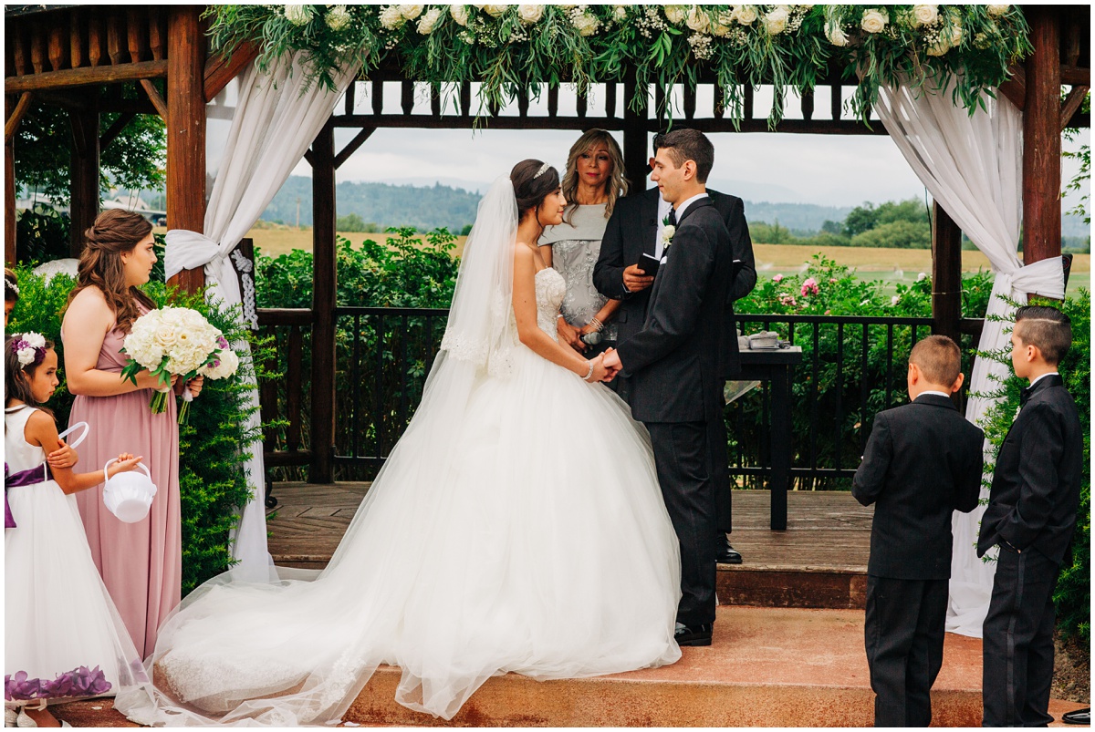 bride and groom at wedding altar | Hidden Meadows Wedding Snohomish Washington