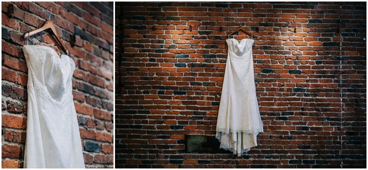 wedding dress hanging on brick wall