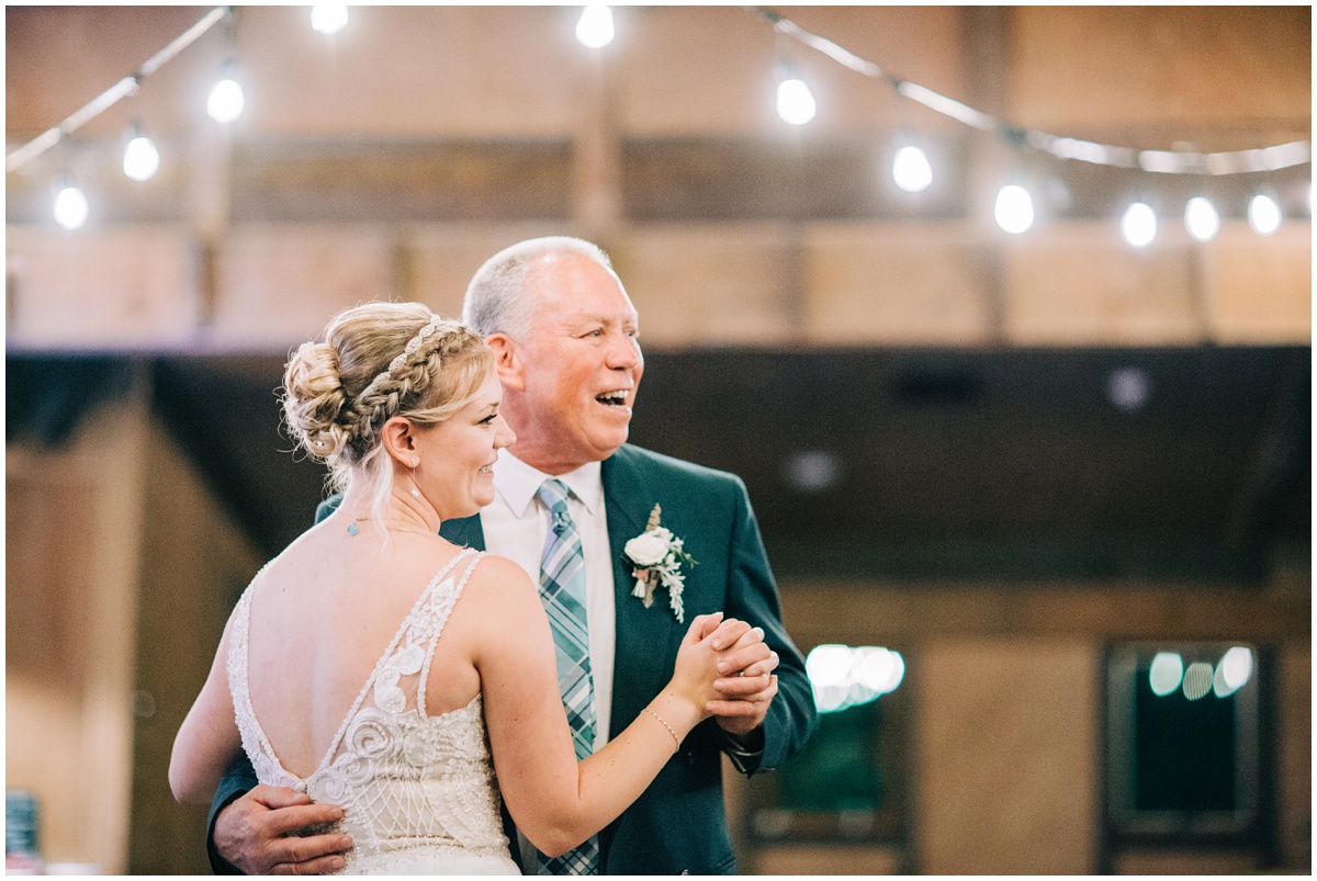 bride and father dancing and smiling