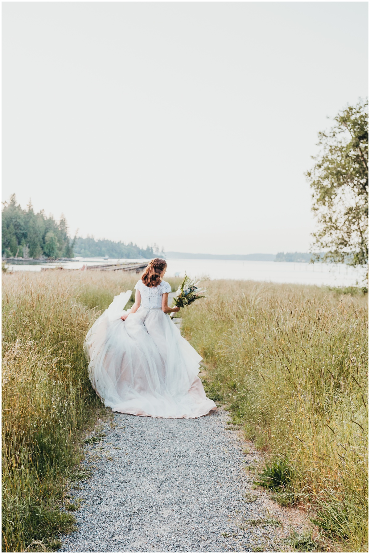 bride running down path holding flowers